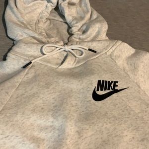 Nike light grey hooded long sleeve sweatshirt with black nike swoosh. Size M.